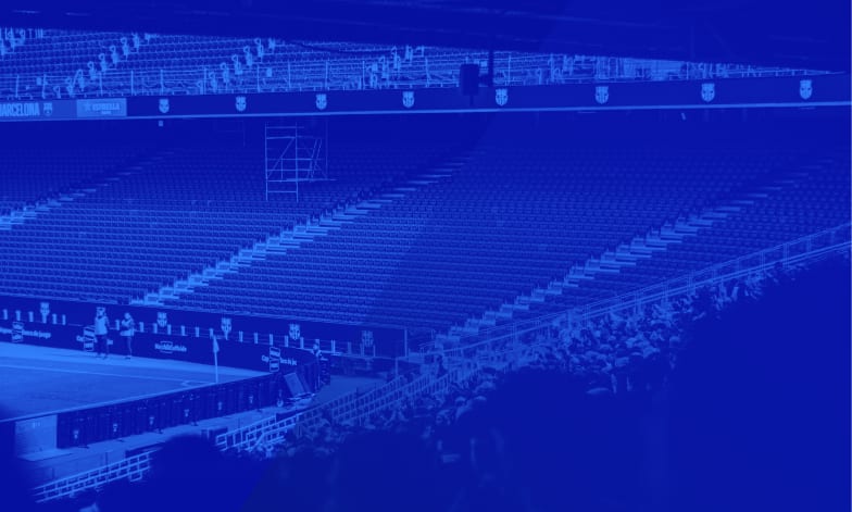 Empty stadium seating bowl in blue duotone, a fan-facing view of the infrastructure behind a sports app