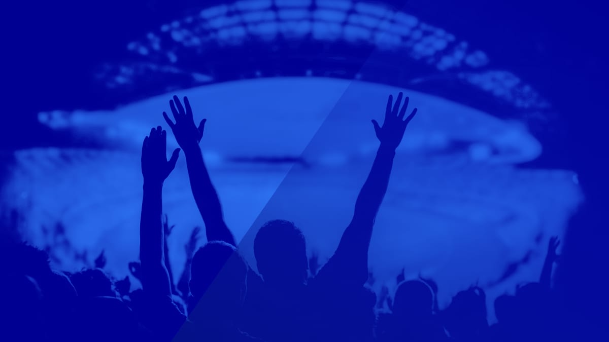 Sports fans celebrating in a stadium — post-event engagement in sports apps